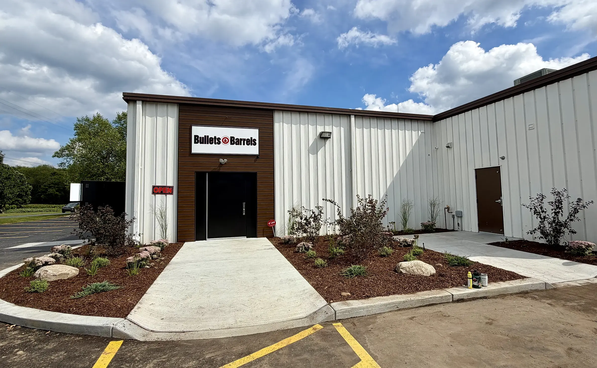 The entrance of a commercial building with new planting beds on both sides of the walkway
